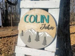 Round Personalized Nursery Name Sign With Raised Lettering And Mountain Scene -The Farmer’s Wife WI Deals Store Round Name Sign 1